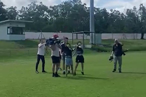 The ball collides with the man’s camera.