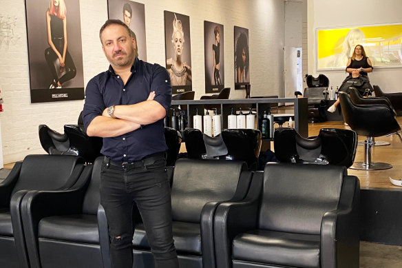 Salon owner Nick Yannas pays about $300 in energy bills each month. 