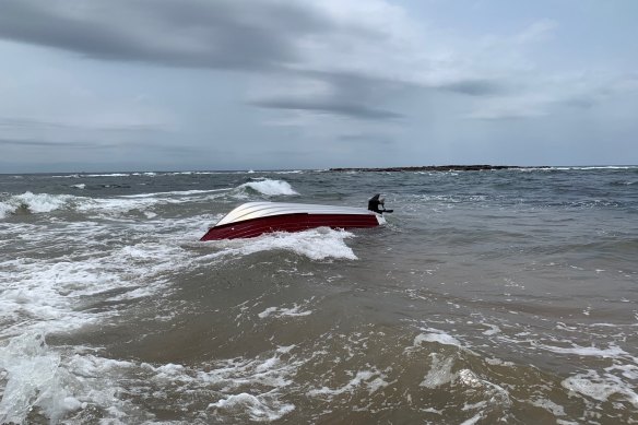 The 12-foot boat overturned after being hit by a rogue wave in calm conditions. 