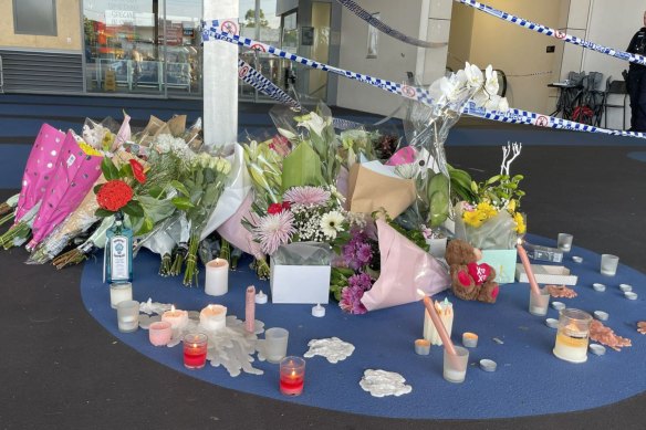 Flowers and tributes left at the Redbank Plains shopping centre where grandmother Vyleen White was stabbed to death.