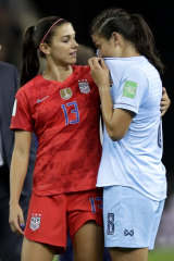 United States' Alex Morgan, left, comforts Thailand's Miranda Nild, right.