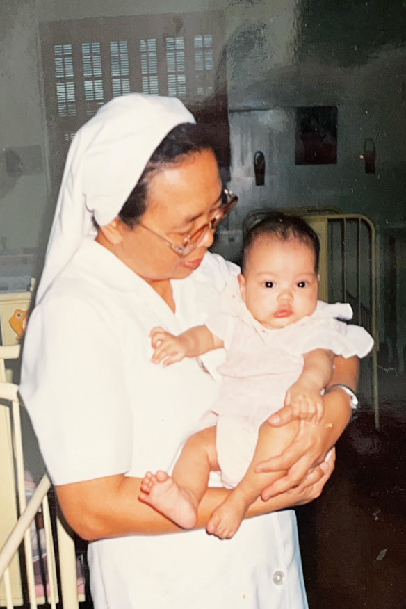 Rache Mahon as a baby with a nun at an orphanage in Quezon City, Philippines, before she was adopted.