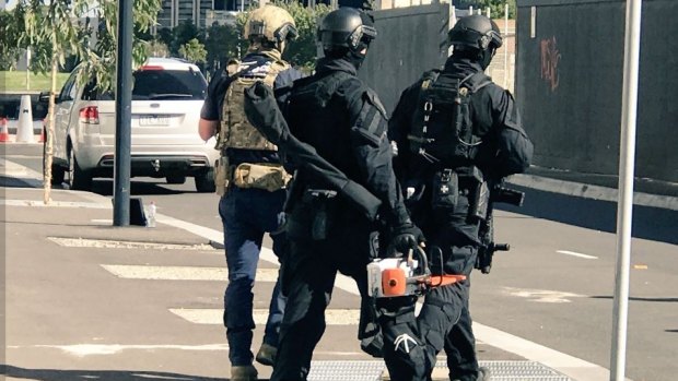 Armed police swarmed the Docklands apartment on Monday.