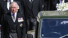 Prince Charles walks alongside the car carrying his father’s casket during the funeral procession for the Duke of Edinburgh.