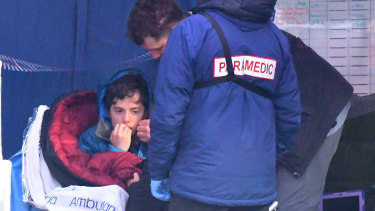 William Callaghan with his stepfather and a paramedic after being found safe and well.