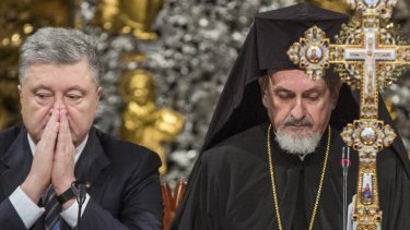 Ukrainian President Petro Poroshenko, left, and Metropolitan Emmanuel attend a closed-door synod  in the St Sophia Cathedral in Kiev on Saturday.