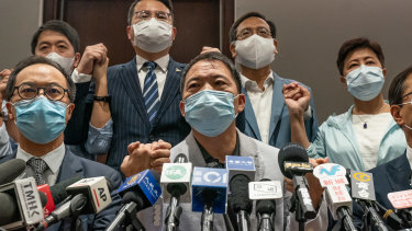 Pro-democracy lawmakers join hands during a press conference at the Legislative Council building on Wednesday..