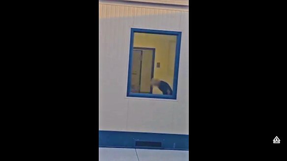 An image from video footage showing the Canadian woman in her room, before the window was blacked out by guards. 