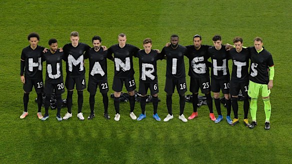 The German soccer team stage a protest at the start of their World Cup qualifier against Iceland in March.