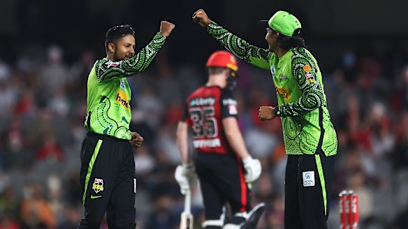 Tanveer Sangha and Jason Sangha celebrate a wicket. 