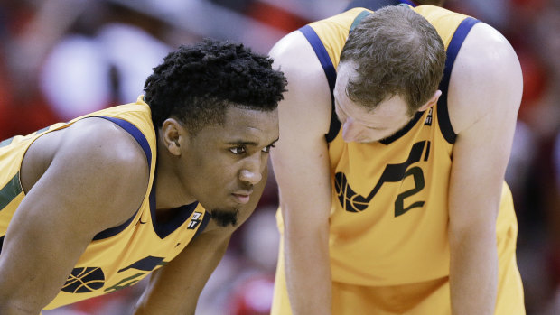 Utah's Donovan Mitchell and Joe Ingles pause during a timeout.
