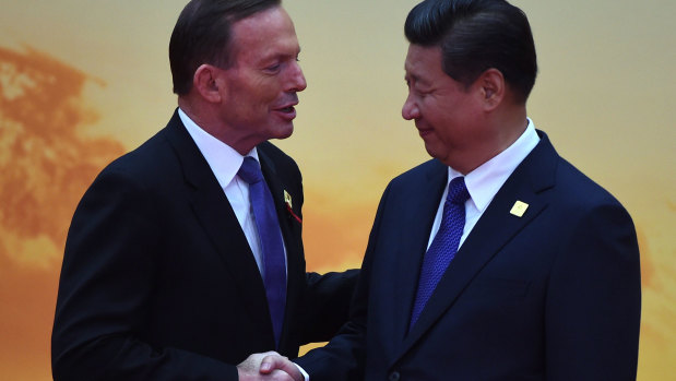 Then Prime Minister Tony Abbott shakes hands with China's President Xi Jinping as he arrives for the Asia-Pacific Economic Cooperation (APEC) leaders meeting north of Beijing in November  2014.