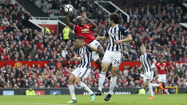 Manchester United's Paul Pogba goes for the ball against West Bromwich Albion at Old Trafford on Sunday.