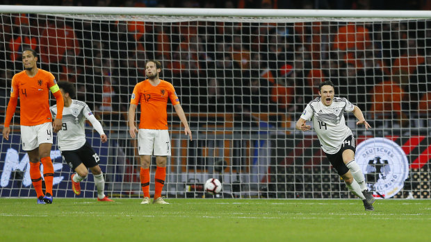 Nico Schulz celebrates netting the winner in Germany's Euro 2020 group C qualifier against the Netherlands.