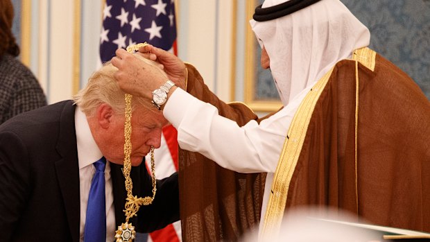 Saudi King Salman presents Donald Trump with The Collar of Abdulaziz al-Saud Medal at the Royal Court Palace last year.