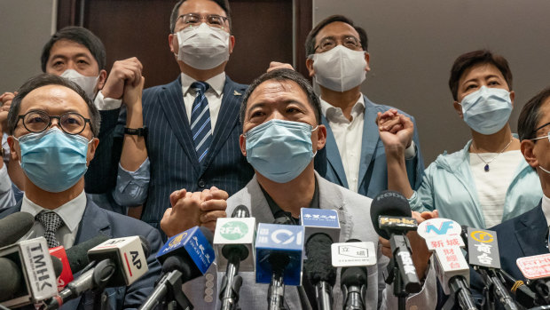 Pro-democracy lawmakers join hands during a press conference at the Legislative Council building on Wednesday..