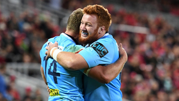 Harry Johnson-Holmes gives teammate Cam Clark a big hug while in action for the Waratahs. 