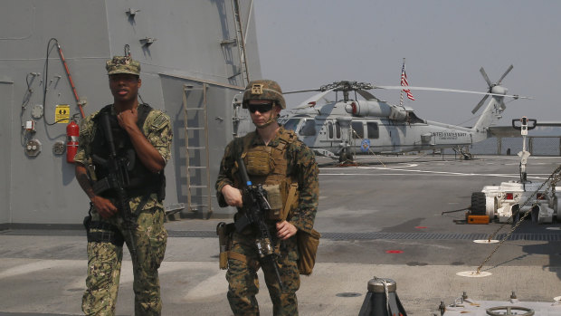 US marines patrol the USS Blue Ridge as it anchors off Manila, Philippines. America has vowed to "sail, fly and operate wherever the law allows us to" amid China's objections in the South China Sea.