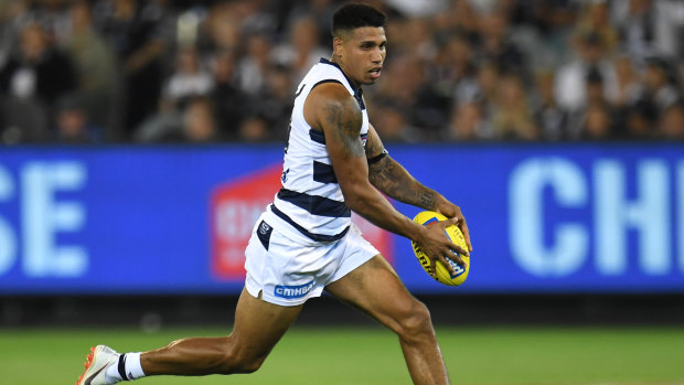 Top Cat: Tim Kelly on the run for Geelong against Collingwood.