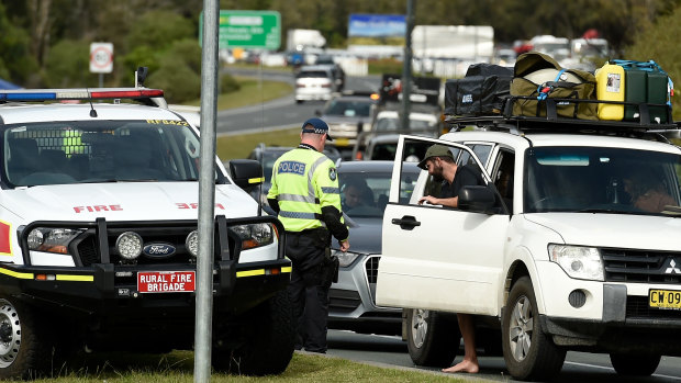 Police check cars for permits at the border checkpoint in Coolangatta at the Gold Coast.
