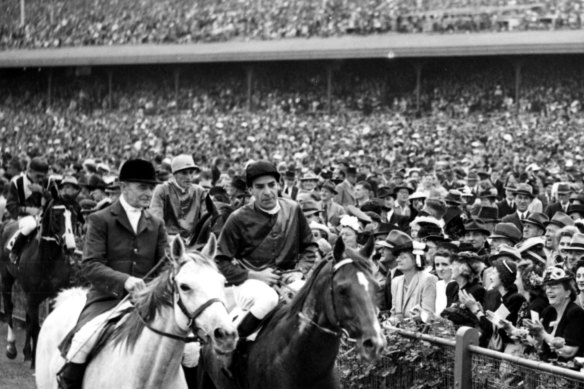 Darby Munro, pictured after winning the 1946 Melbourne Cup on Russia,  coined the phrase “Meat Pie Champion”.