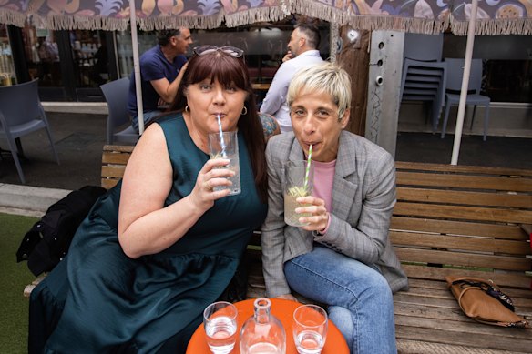 Jody Brodribb and Joanne Taylor celebrate the easing of restrictions in Yarraville on Friday afternoon.