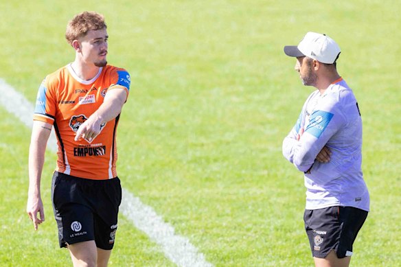 Lachie Galvin and coach Benji Marshall make eye contact at Tigers training on Thursday.