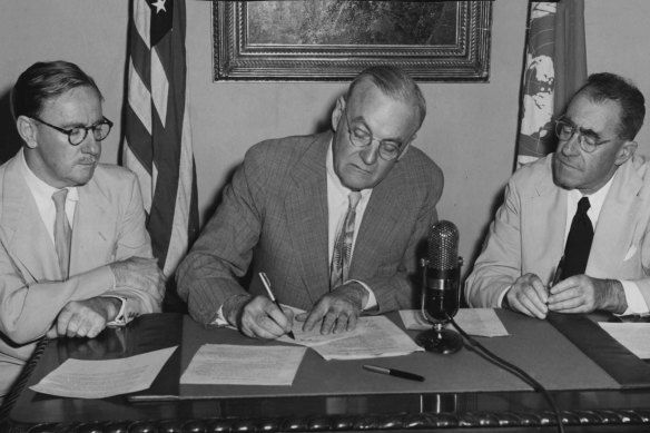 US State Department representative John Foster Dulles, flanked by the Australian and New Zealand ambassadors to the US, Sir Percy Spender, left, and Sir Carl Berendsen, at the initialling of the ANZUS Treaty in San Francisco in 1951.