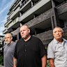 Adam Denyer, Peter Bishenden, and Sebastian Mignacca outside their apartment building in Sutherland.