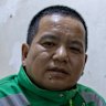 Mu Jie, 49, makes little more than the equivalent of $1.20 per order as a driver for instant grocery delivery platform Xiaoxiang (Little Elephant) in Beijing.