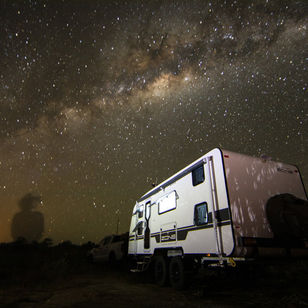 Simon and Liz Bailey’s caravan under the starry outback sky, with an outline of Simon on the horizon. The family are on the road “full-time and indefinitely”. 