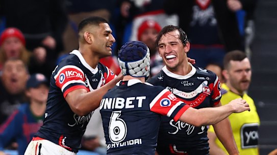 Roosters centre Billy Smith (right) celebrates his try on Saturday night.