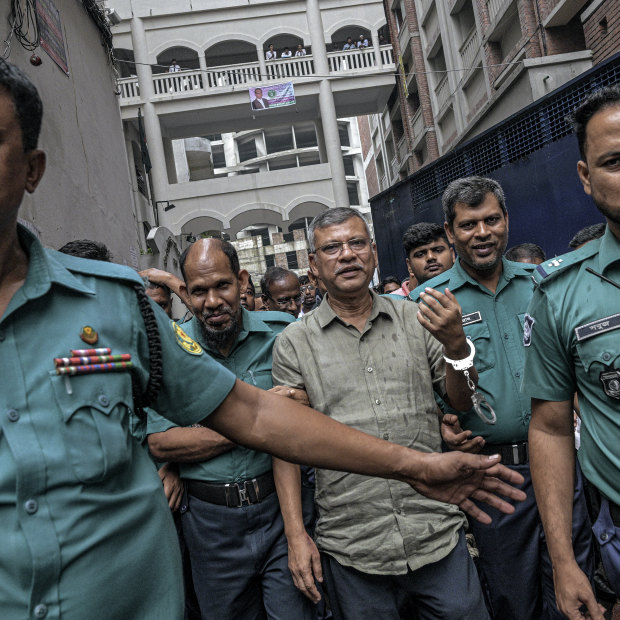 Police usher Saiful Alam Nirob, a Bangladesh Nationalist Party leader, to his court case.