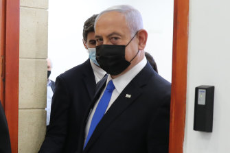 Israeli Prime Minister Benjamin Netanyahu, right, leaves court during his corruption trial on Monday.