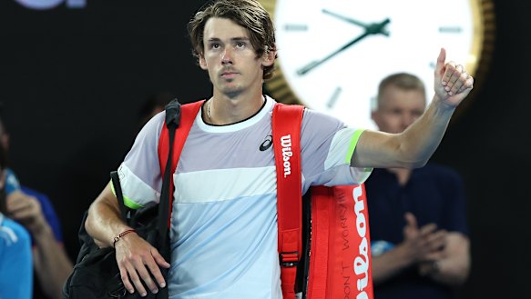 Alex de Minaur walks off after losing in straight sets to Novak Djokovic in their fourth round match.