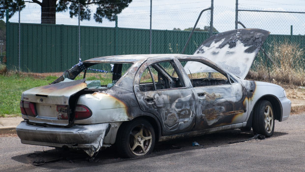 The burnt out wreck of a car set on fire on Christmas Day on Narrabundah Lane, Symonston.