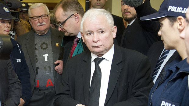 Poland's two most famous foes, the country's de facto leader, head of the ruling party Jaroslaw Kaczynski, right, and former President Lech Walesa, second left, stand near each other after exchanging wry comments before a courtroom in Gdansk, Poland, in November.