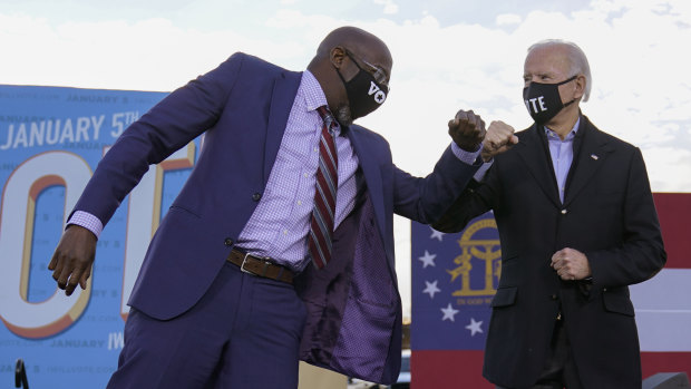 Democratic Senate candidate Raphael Warnock campaigning with President-elect Joe Biden at a rally in Atlanta.