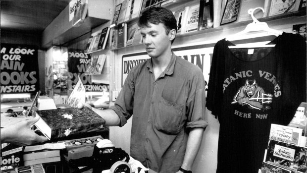"Public demand for the book is at fever pitch..." A copy of The Satanic Verses is sold at The Busy Book shop, George Street on March 10, 1989.