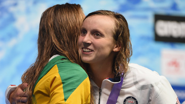 Katie Ledecky hugs Ariarne Titmus on the podium at the 2018 Pan Pacs.