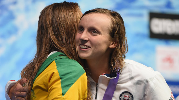 Rivals: Katie Ledecky hugs Ariarne Titmus on the podium.