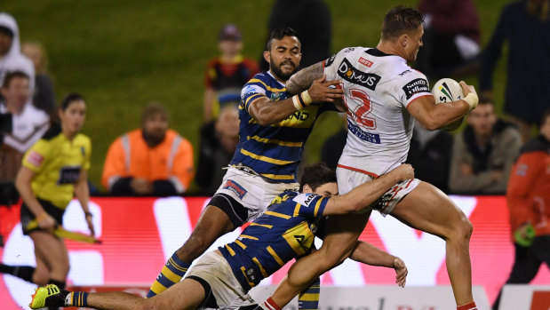 Head of steam: Tariq Sims bends the Eels defence with the Dragons.