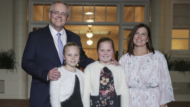 Prime Minister Scott Morrison with his wife Jenny and daughters Abigail and Lily pose for photos after being sworn-in at Government House in Canberra on Friday.