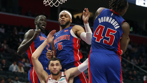 In the mix: Detroit Pistons forward Sekou Doumbouya (45) rebounds as Chicago Bulls guard Zach LaVine, bottom left, is pressured by Pistons forward Thon Maker (7) and guard Bruce Brown.