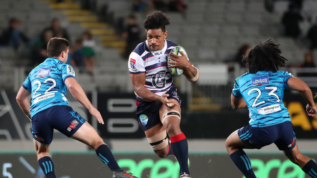 Lopeti Timani (centre) in action for the Rebels. 