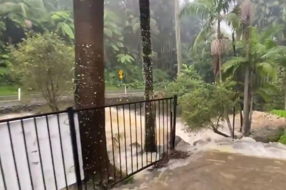 A raging torrent of water is threatening the Curtis Falls Cafe. Council crews are trying to clear blocked drains across the road. 