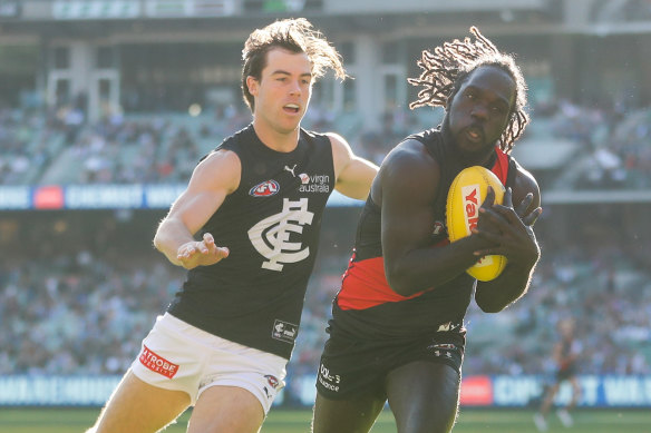 Anthony McDonald-Tipungwuti takes a mark ahead of Lachie Plowman.