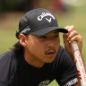 Min Woo Lee lines up a putt on day three of the Australian Open.