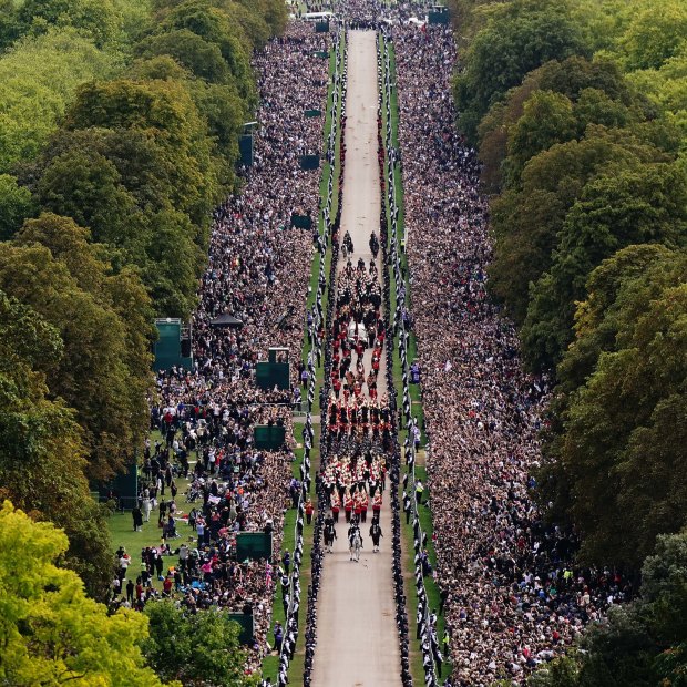 Crowds at Windsor watch as the Queen’s hearse appraoches the castle. 