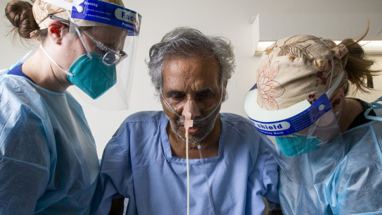 COVID 19 survivor Vishwanathan Nair and  ICU physiotherapists Kimberley Haines (right)  and Nina leggett at Footscray Hospital.